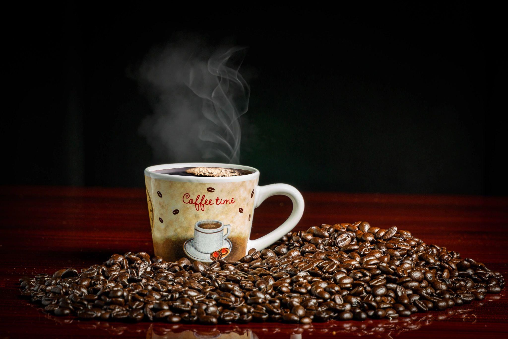 A cup of coffee on a bed of coffee beans