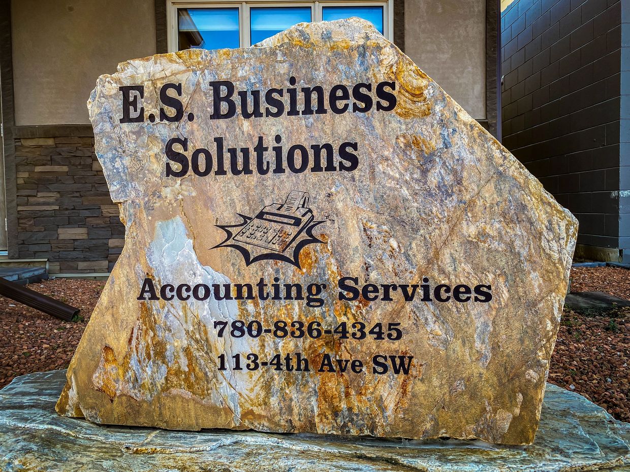 Stone tablet with business name, contact number and address