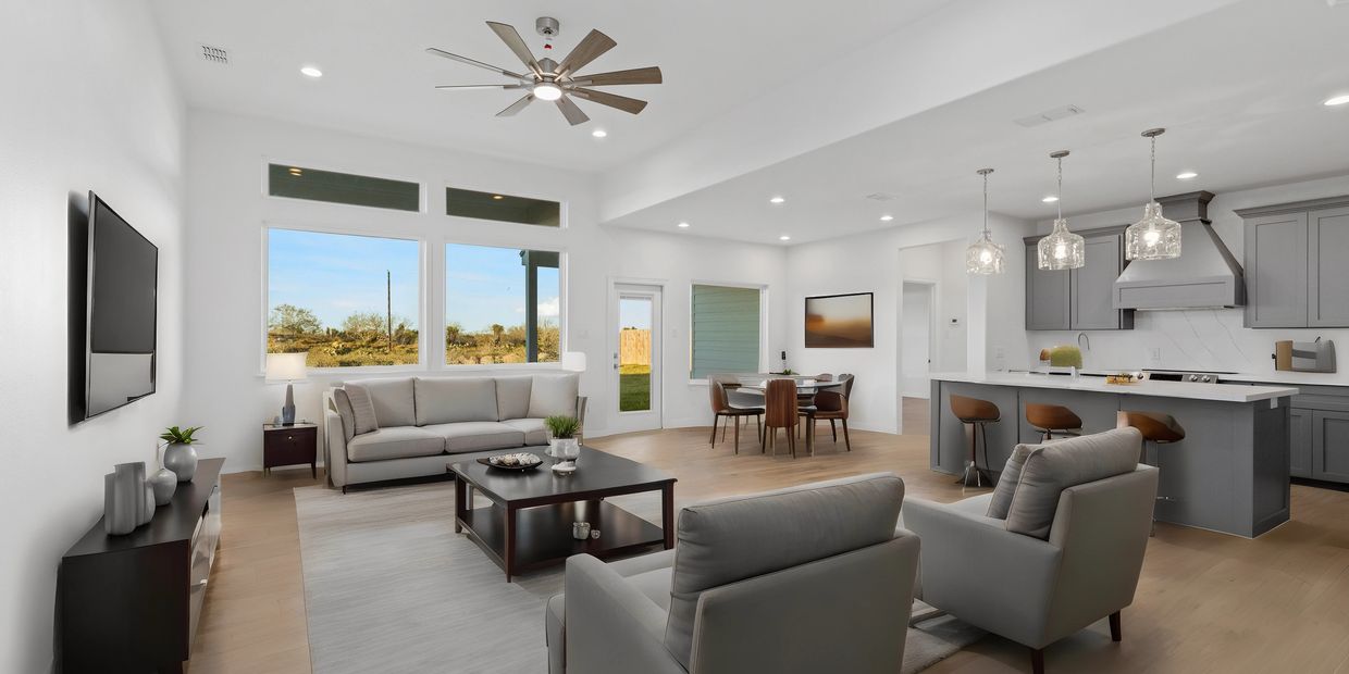 A sample image of a virtually staged living room, dining room, and kitchen by ArcTechPHOTO.