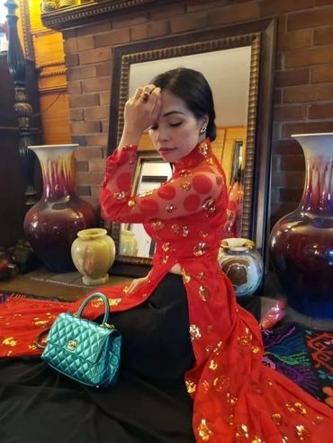 Woman in red lace dress with teal bag