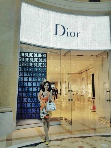 Woman posing at Dior store entrance