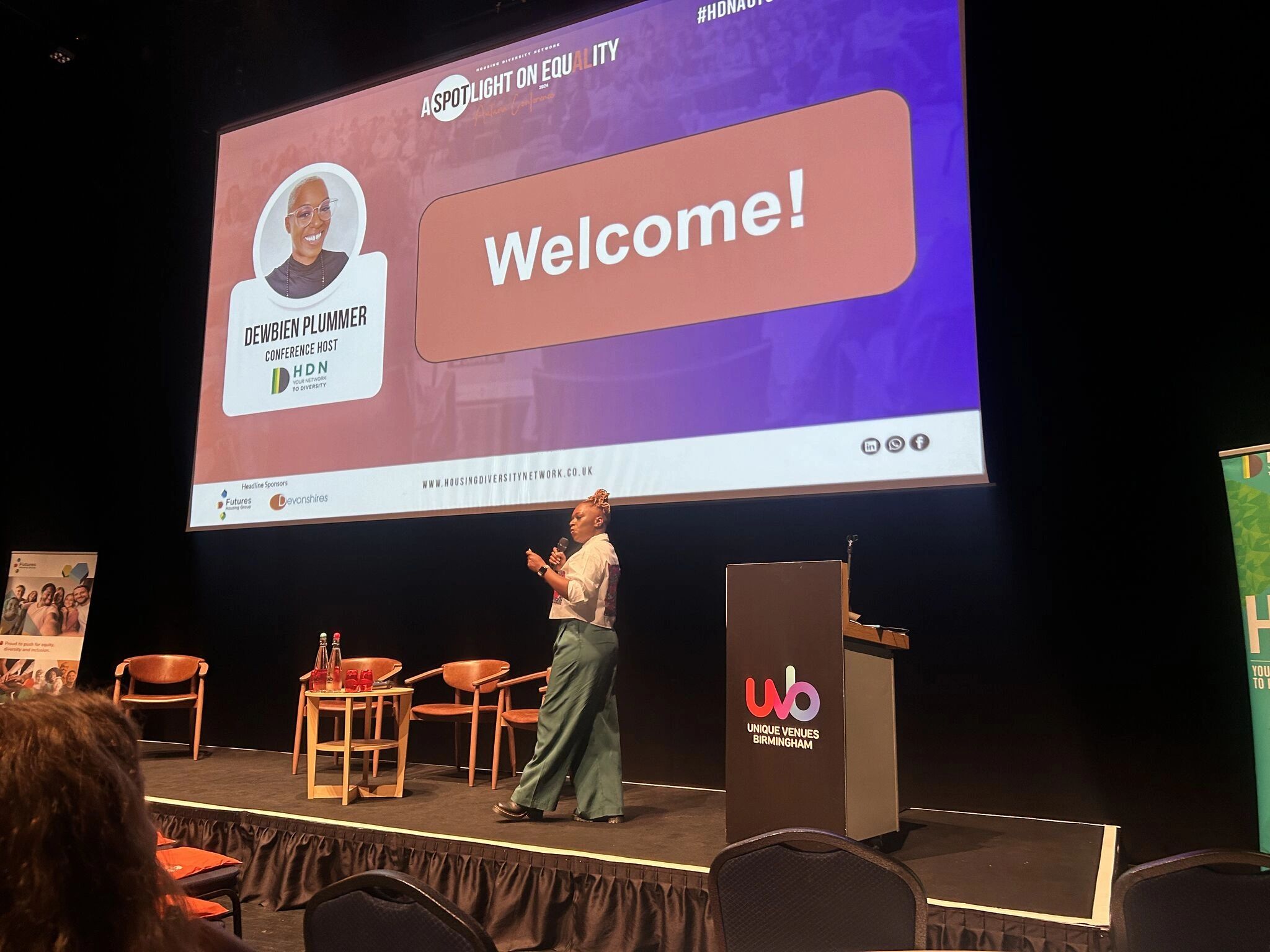Picture of Dewbien speaking as a conference host.