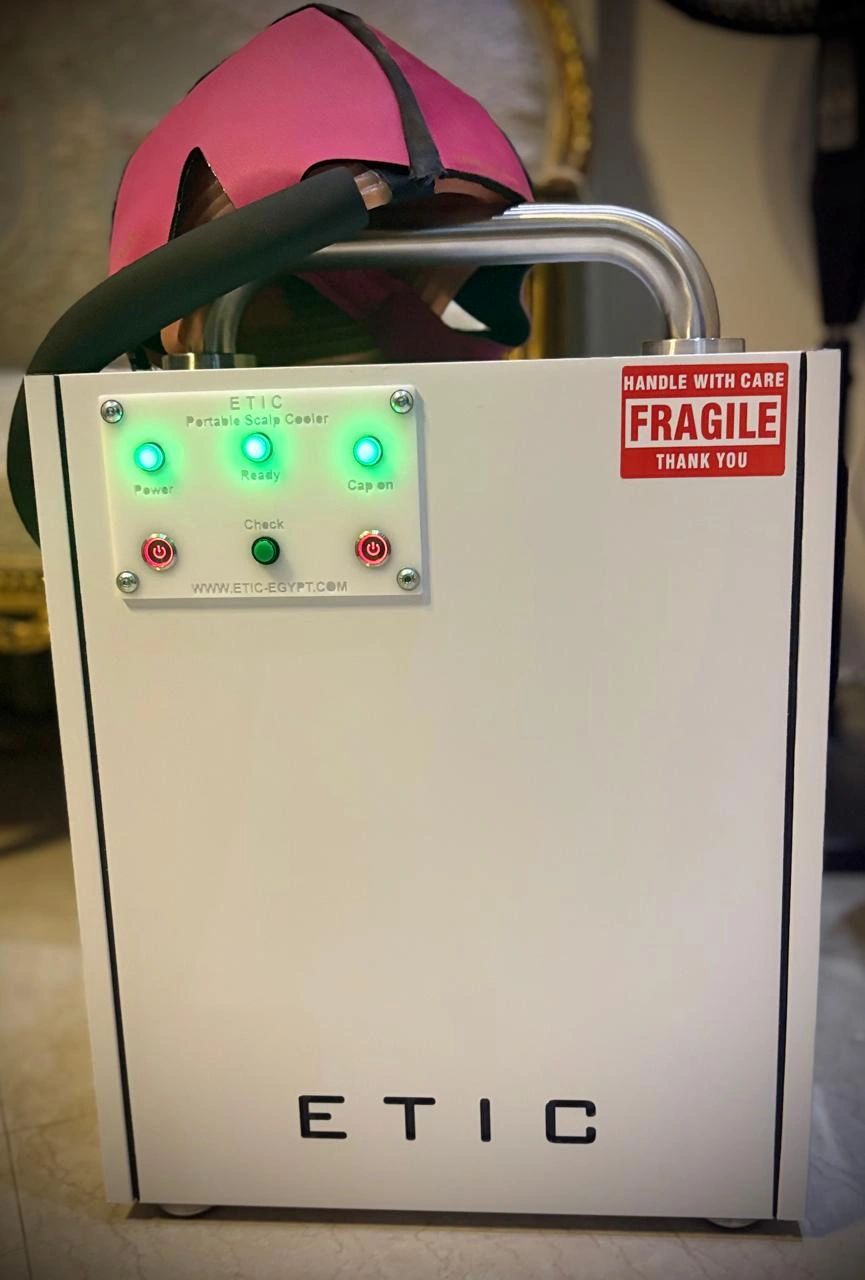 ETIC portable scalp cooler with glowing indicators and a fragile warning.