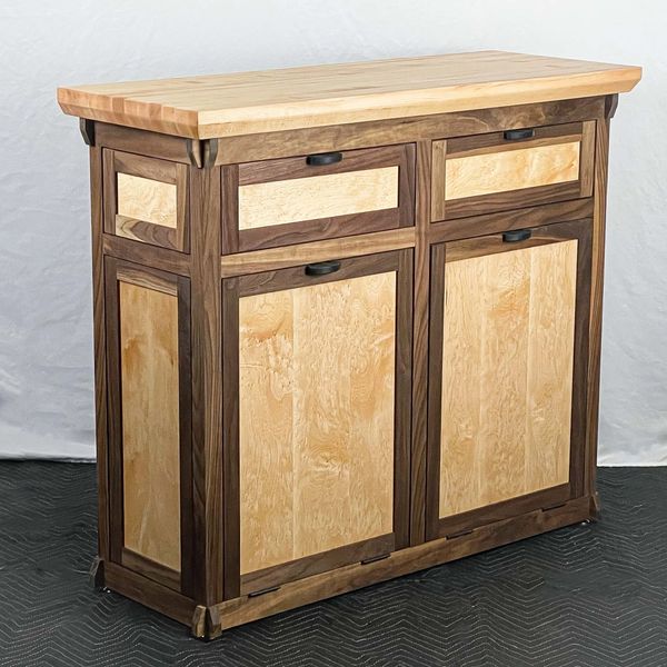 Freestanding kitchen island with butcherblock top. Two drawers and two tilt out compartments 