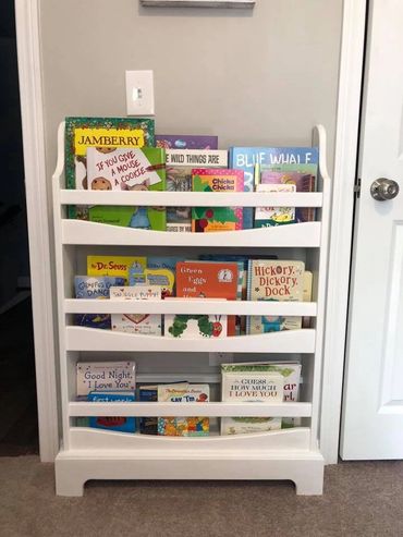 custom furniture. bookshelf for child's room. painted white. three shelves. slim profile. 