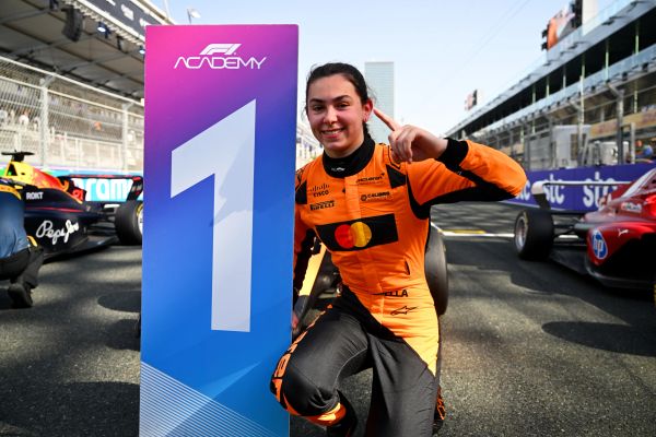 Race car driver celebrates first place.