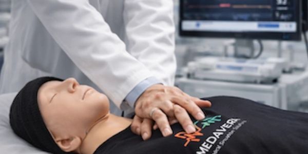 Medical professional performing CPR on a training mannequin.