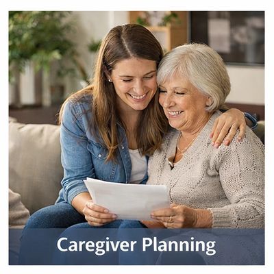 Young woman and elderly lady smiling while reviewing documents together.