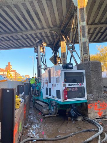 Construction drilling machine under a bridge.
