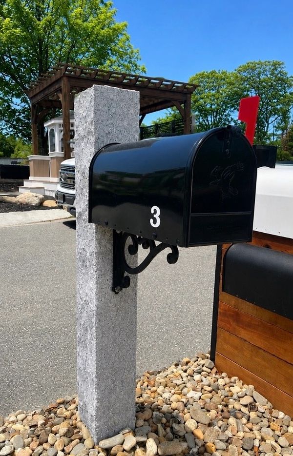 Black mailbox with number 3 on a gray post.