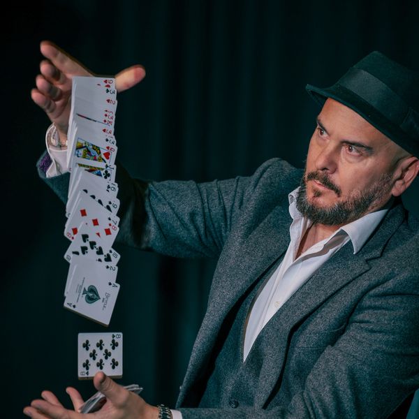Ady Lloyd performing close-up card magic with focus and precision as a London magician and mind reader