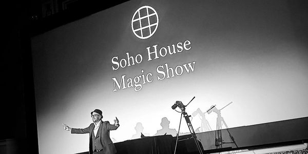 Ady Lloyd performing stage magic and mind reading at a Soho House Magic Show in London