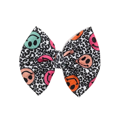 Colorful smiley face bow with leopard print background.