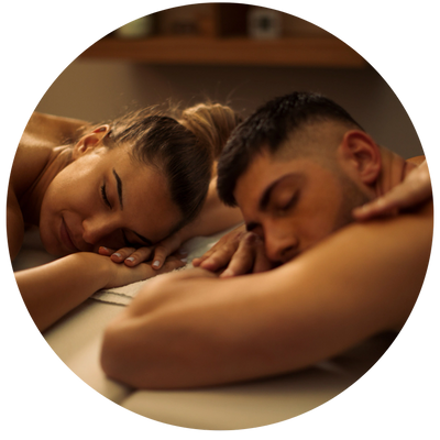 Couple relaxing side by side during a massage session.