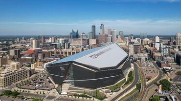 Aerial view of U.S. Bank Stadium with city skyline.