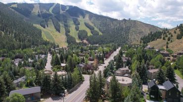 Mountain town with ski slopes and houses.