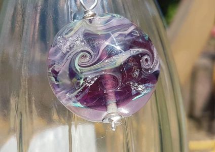 Purple glass lentil containing ashes  cremation memorial keepsake themoltenpixie 