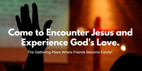 A raised hand at a worship event inviting people to encounter Jesus and God's love.