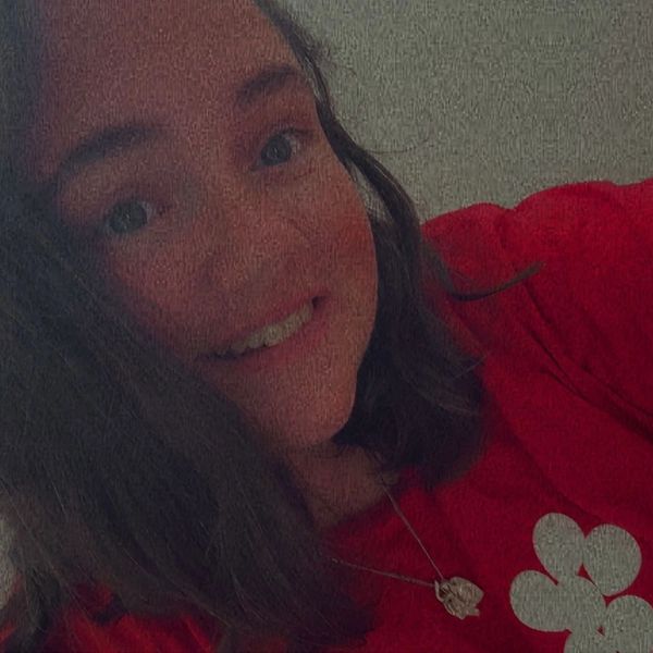Image of woman wearing a Red top smiling.