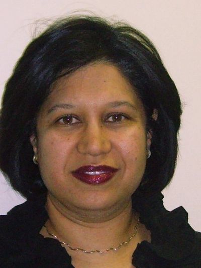 Portrait of a woman with dark hair and bold lipstick.
