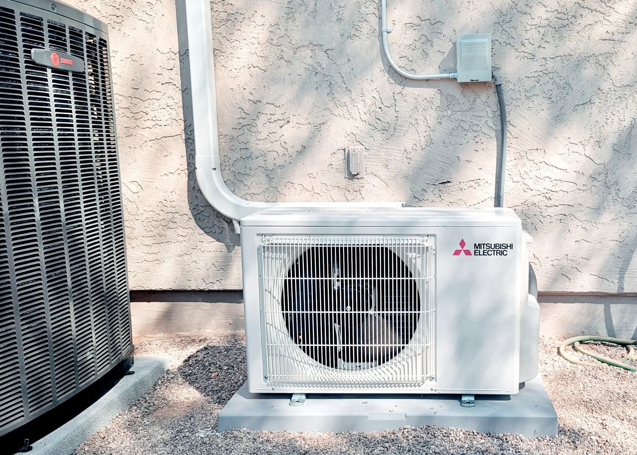 A residential outdoor unit of a Mini-Split, installed by AirPro Cooling and Heating. 