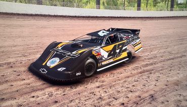 Black and yellow race car on a dirt track.