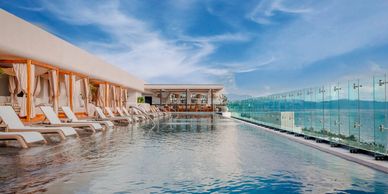 Roof top pool overlooking sunset in Mexico.