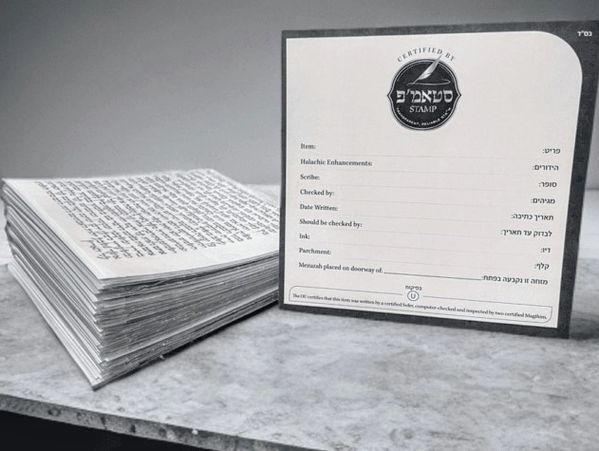Stack of handwritten Hebrew documents next to a certification card.