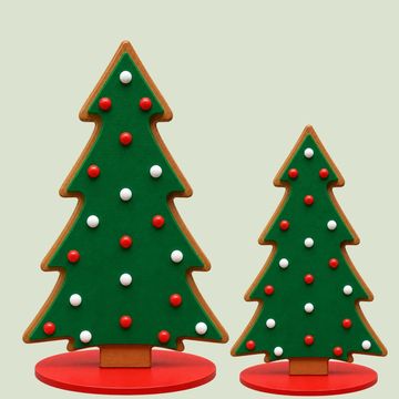Two Christmas tree-shaped cookies decorated with red and white icing.
