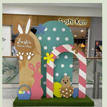 Easter-themed mall display with bunny and egg decorations.