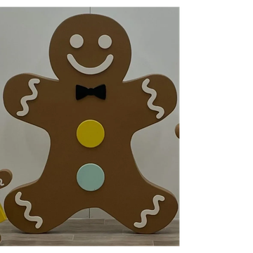 Large gingerbread man decoration with colorful buttons and bow tie.