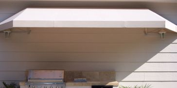 Canvas awning over BBQ pit outdoor kitchen Sunbrella canvas awning by Conroe Awning and Screen