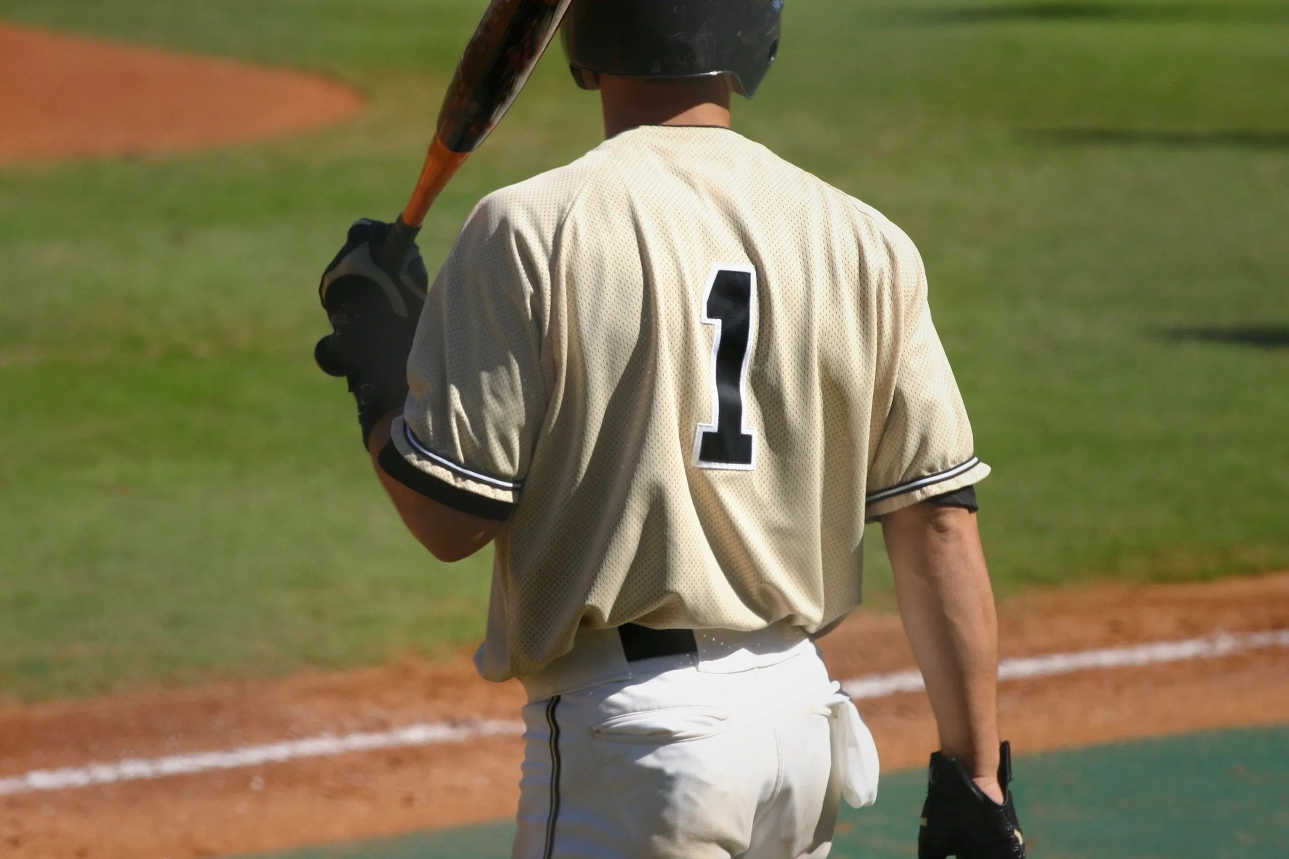 Baseball player ready to bat with helmet and glove.