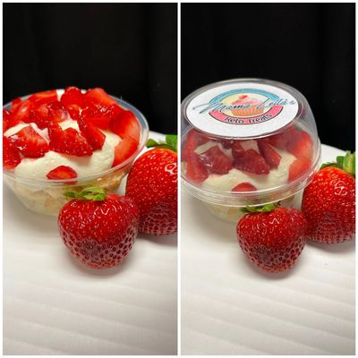 Fresh strawberries with creamy dessert in a clear cup.