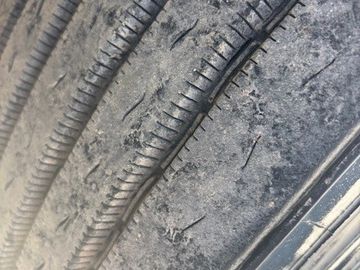 Close-up of a worn-out tire with smooth, damaged tread.