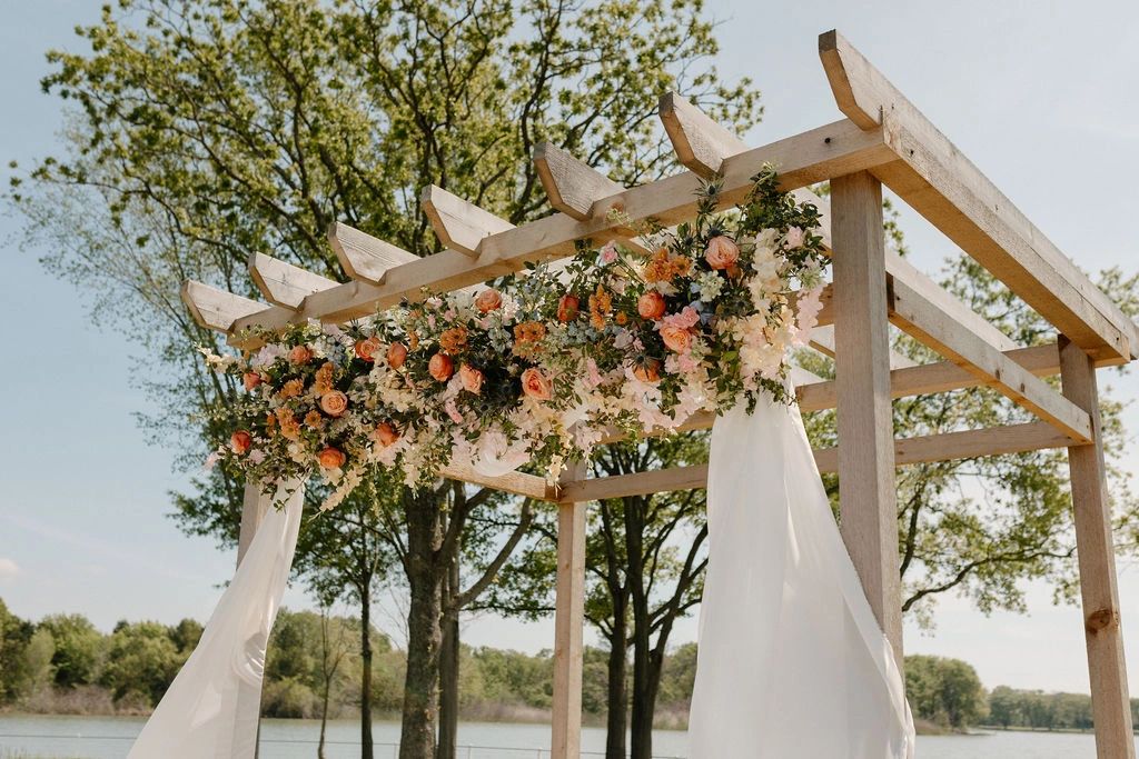 Decorated wedding arch for a lakeside wedding venue in Corsicana TX.