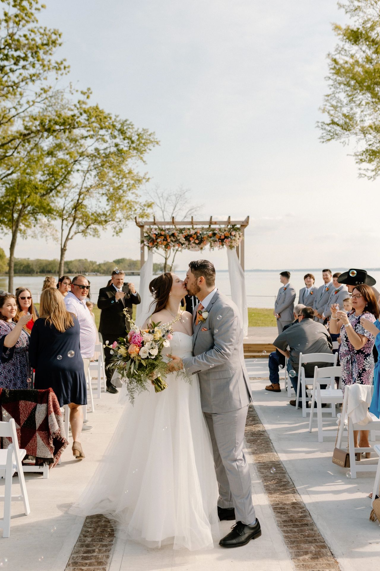 Bride and groom kissing after the wedding ceremony at Kerens wedding venue near Dallas.