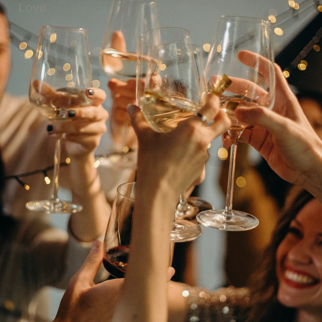 Dallas wedding venue cocktail hour. Wedding guests celebrating with wine.