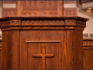 Wooden church pulpit with a cross.
