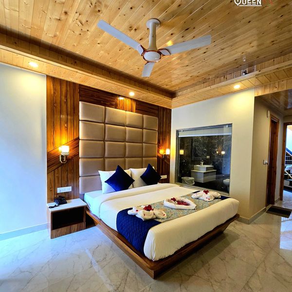 Modern bedroom with wooden ceiling and elegant bed setup.