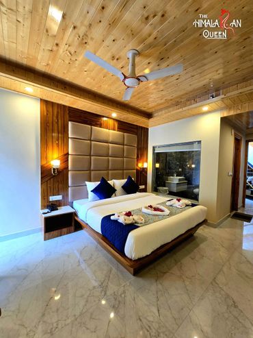 Modern bedroom with wooden ceiling and elegant bed setup.
