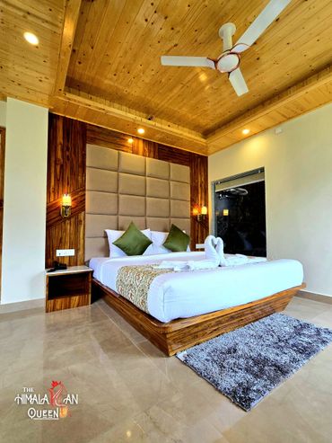 Modern wooden bedroom with a cozy bed and ceiling fan.