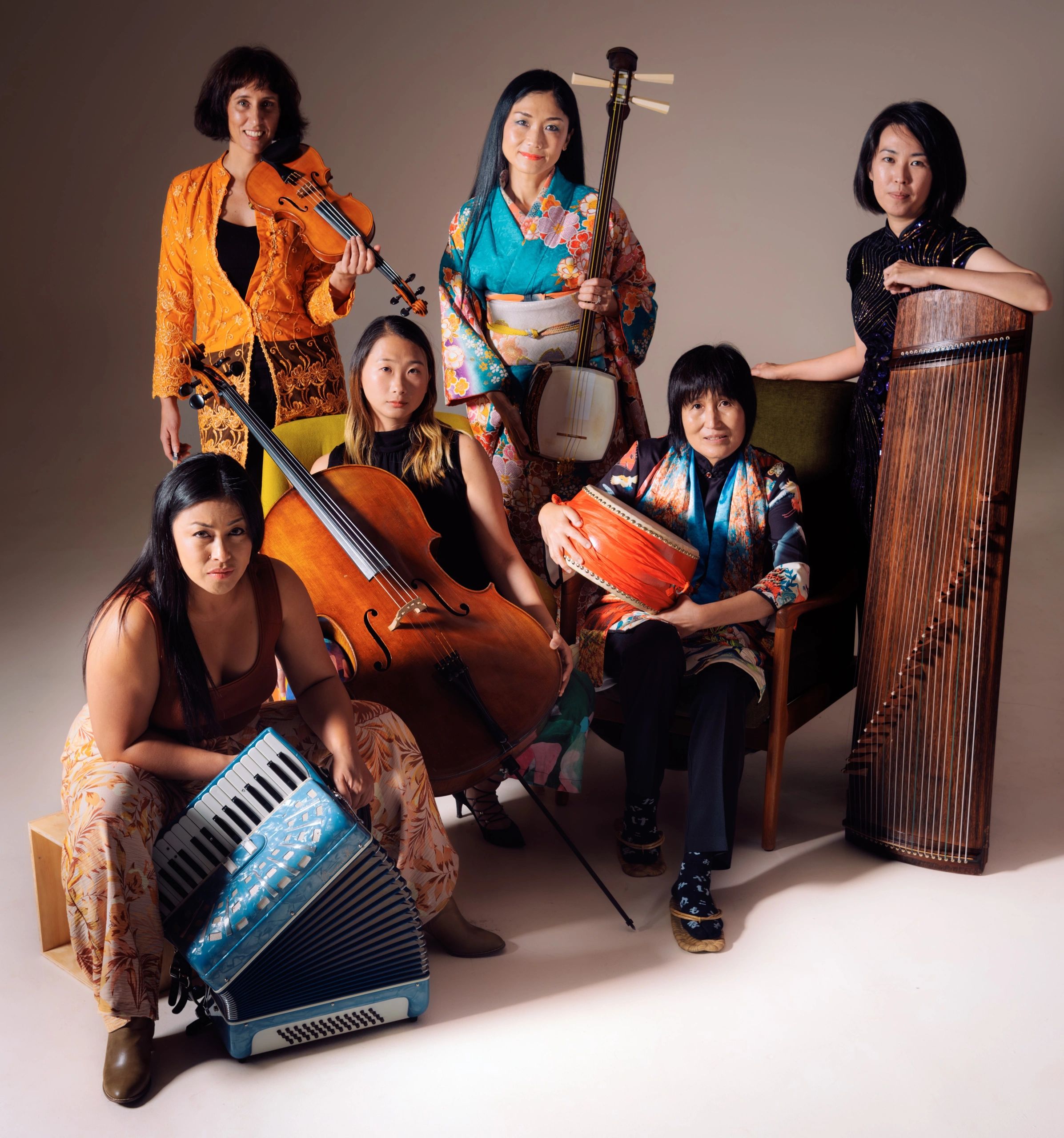 Six female musicians holding their instruments: violin, shamisen, guzheng, accordion, cello, taiko.