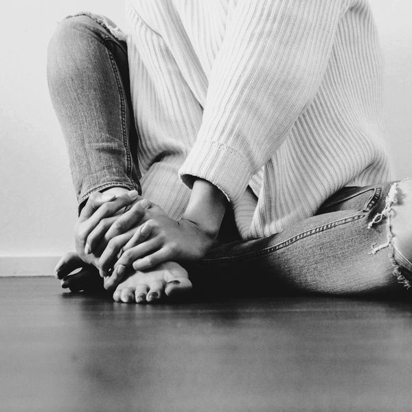 woman sitting cross legged.