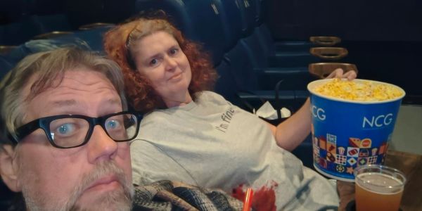 Couple enjoying popcorn at the movies.