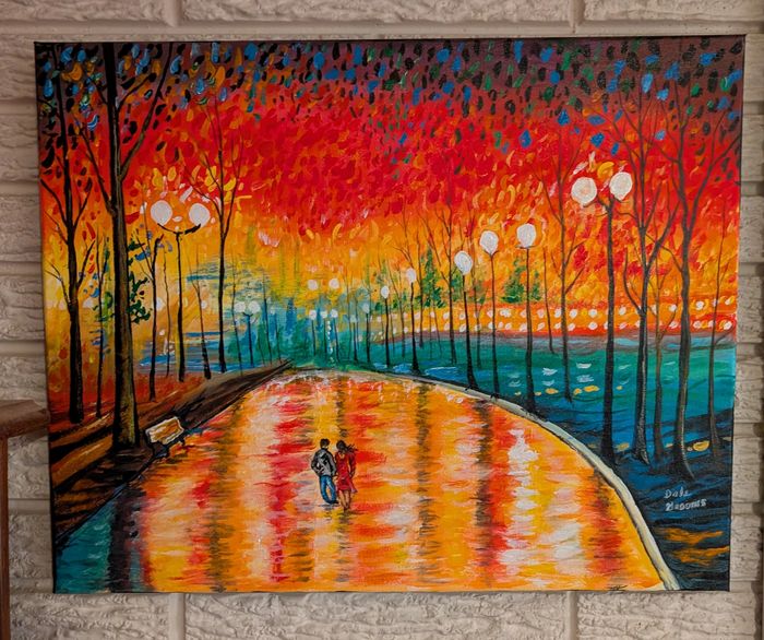 a couple walks on a wet sidewalk enjoying the colorful evening sunset
