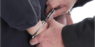 handcuffs being applied to a man's wrists