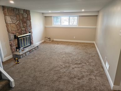 Basement renovation with browns and tans. Fireplace.