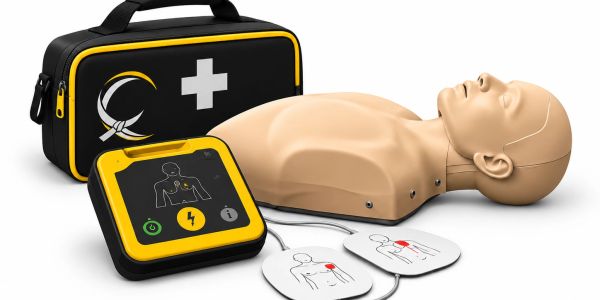 CPR training kit with dummy and AED device.