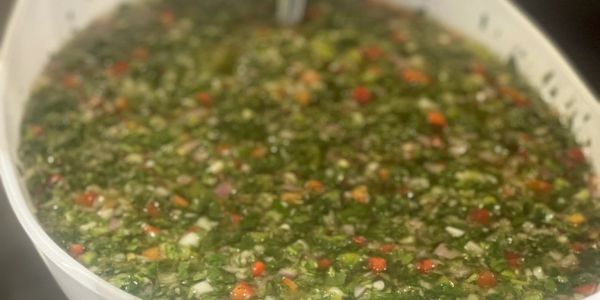 Close-up of a container filled with chopped vegetable sauce or salsa.